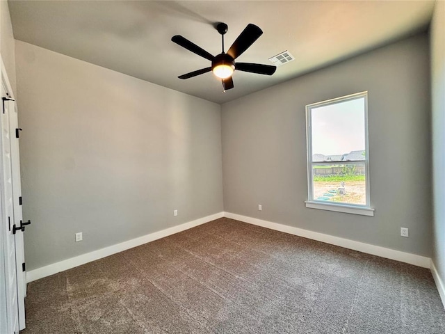 10116 NW 100th St, Yukon, OK 73099 - spare room with dark carpet and a ceiling fan