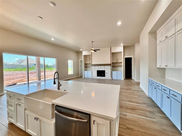 10132 NW 100th St, Yukon, OK 73099 - kitchen with dishwasher, ceiling fan, a tiled fireplace, recessed lighting, and open floor plan