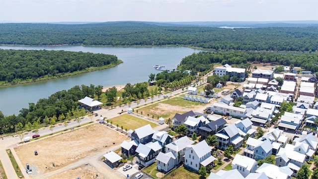 aerial view featuring a water view and a wooded view