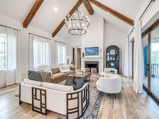 living area with high vaulted ceiling, a healthy amount of sunlight, beam ceiling, and light wood-style floors