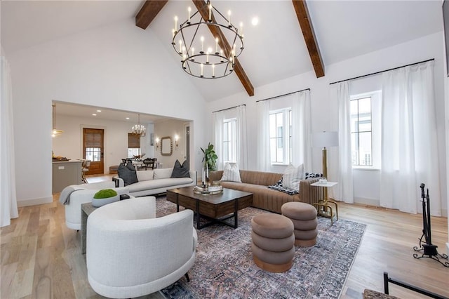 living area with high vaulted ceiling, a notable chandelier, beam ceiling, and light wood-type flooring