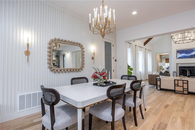 dining area featuring vaulted ceiling, light wood-type flooring, a notable chandelier, visible vents, and recessed lighting