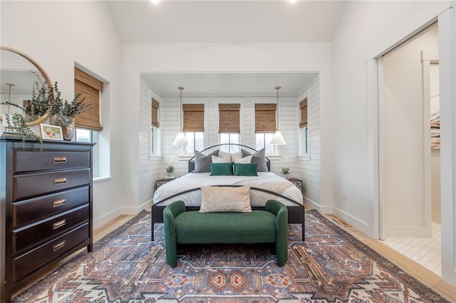 bedroom with wood finished floors and baseboards