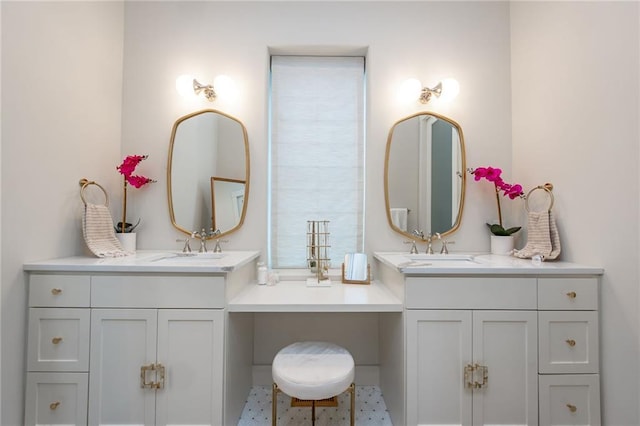 full bathroom with two vanities and a sink