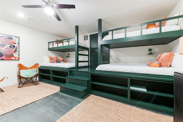 bedroom with concrete flooring, visible vents, a ceiling fan, and baseboards