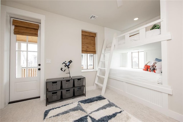 bedroom featuring baseboards, visible vents, carpet, and multiple windows
