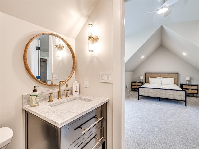 bathroom featuring vaulted ceiling, a ceiling fan, and vanity