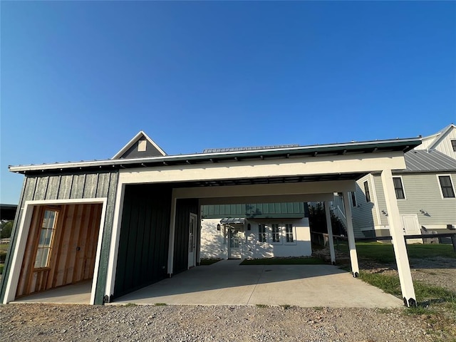 view of front of property with board and batten siding and a carport