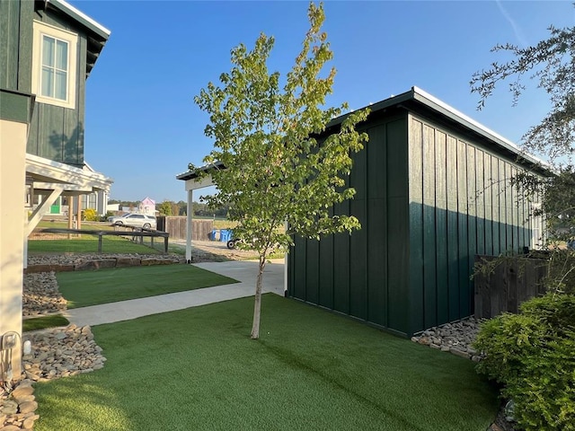 view of home's community featuring fence and a yard