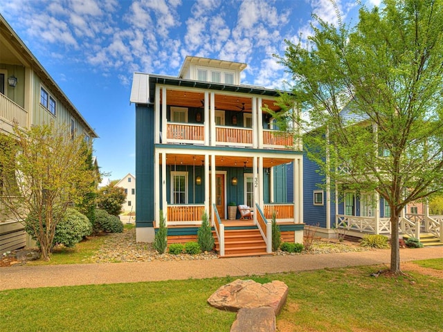 view of front of property with a porch, a front lawn, and a balcony