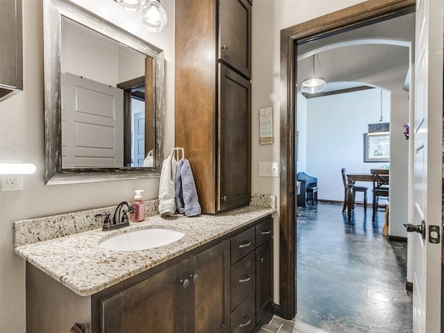 bathroom with vanity and baseboards