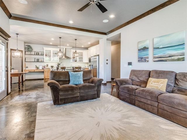 living area with finished concrete floors, ceiling fan, and recessed lighting