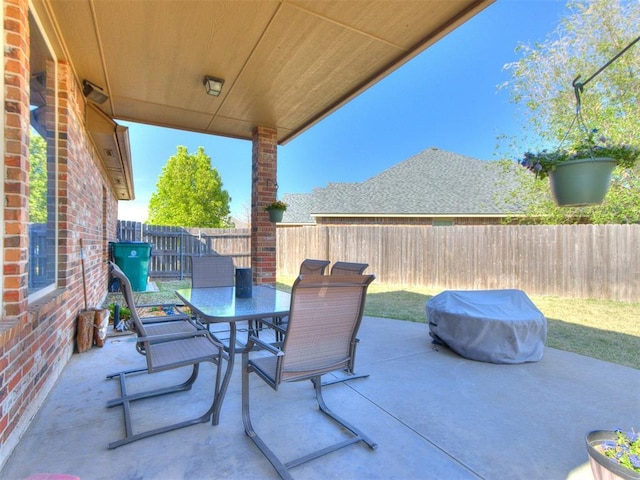 view of patio with outdoor dining area and a fenced backyard