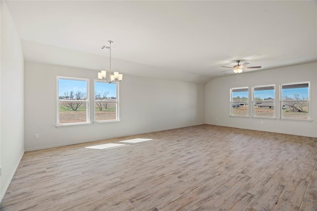 4605 Lincoln Lndg, Harrah, OK 73045 - empty room with a chandelier, light wood-style floors, ceiling fan, vaulted ceiling, and baseboards