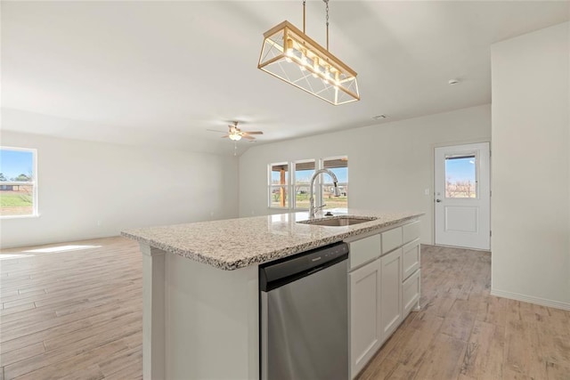 4605 Lincoln Lndg, Harrah, OK 73045 - kitchen with stainless steel dishwasher, a sink, open floor plan, light wood-type flooring, and white cabinets