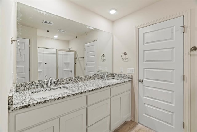 4605 Lincoln Lndg, Harrah, OK 73045 - full bathroom featuring a stall shower, double vanity, and wood finished floors