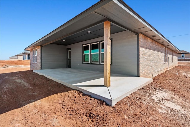 4605 Lincoln Lndg, Harrah, OK 73045 - rear view of property with brick siding and a patio