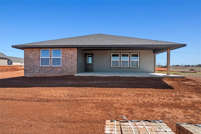 4605 Lincoln Lndg, Harrah, OK 73045 - rear view of property with roof with shingles and brick siding