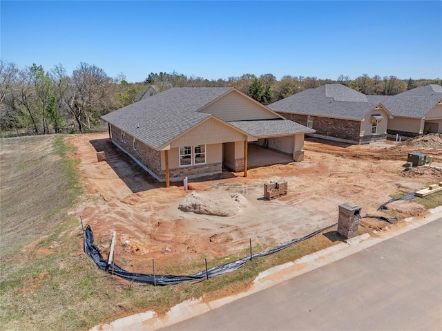 4605 Lincoln Lndg, Harrah, OK 73045 - view of front of house with driveway, a shingled roof, and a garage