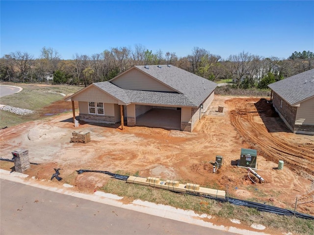 4605 Lincoln Lndg, Harrah, OK 73045 - view of front facade with a shingled roof, a garage, and stone siding