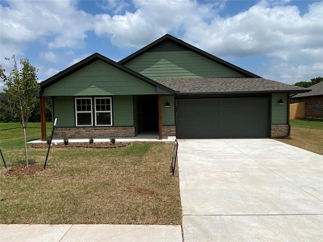 4605 Lincoln Lndg, Harrah, OK 73045 - single story home with a front lawn, an attached garage, driveway, brick siding, and covered porch