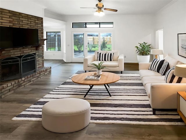 3708 Teresa Dr, Moore, OK 73160 - living room with healthy amount of natural light, ceiling fan, wood finished floors, crown molding, and a brick fireplace