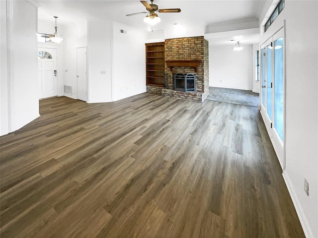 3708 Teresa Dr, Moore, OK 73160 - unfurnished living room featuring ceiling fan, dark wood finished floors, a fireplace, healthy amount of natural light, and ornamental molding