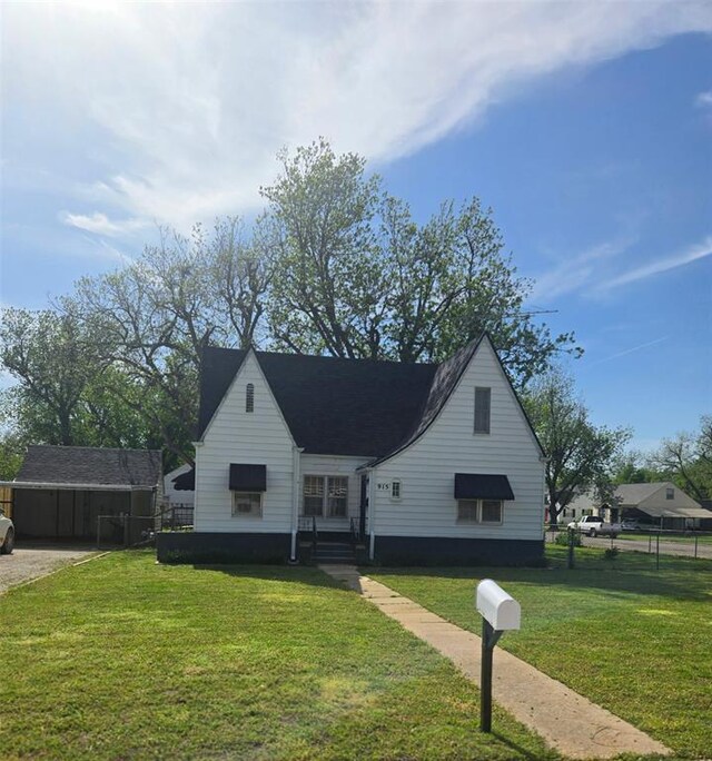 bungalow-style house with fence and a front yard