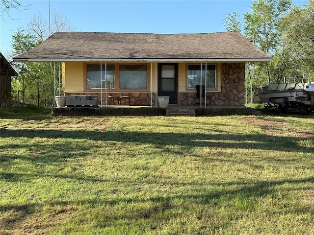 1709 Fisherman Rd, Carnegie, OK 73015 - view of front facade with covered porch, a front yard, and stone siding