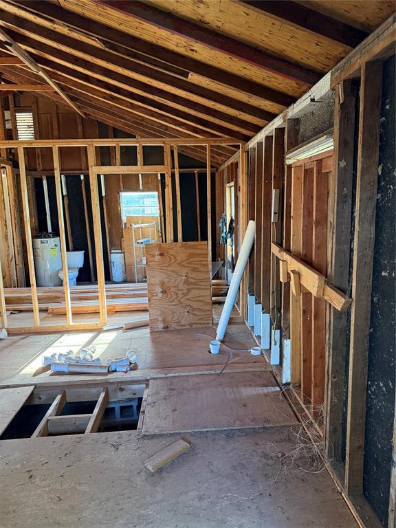 1709 Fisherman Rd, Carnegie, OK 73015 - miscellaneous room featuring electric water heater and vaulted ceiling