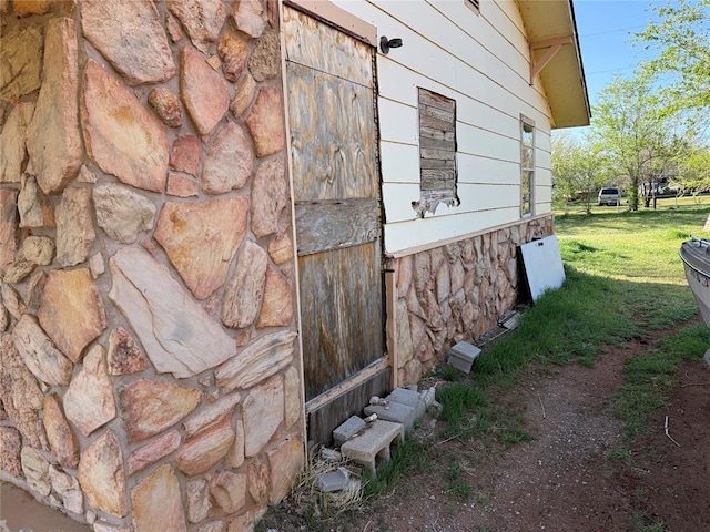 1709 Fisherman Rd, Carnegie, OK 73015 - view of side of home featuring stone siding and a lawn
