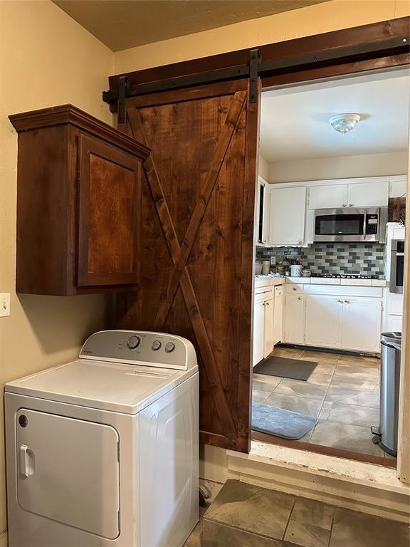 609 Utah Ave, Norman, OK 73069 - laundry room with washer / clothes dryer and cabinet space