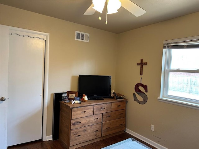 609 Utah Ave, Norman, OK 73069 - bedroom with dark wood-type flooring, visible vents, baseboards, and a ceiling fan