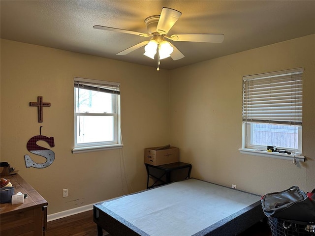 609 Utah Ave, Norman, OK 73069 - bedroom featuring a textured ceiling, baseboards, a ceiling fan, and dark wood finished floors