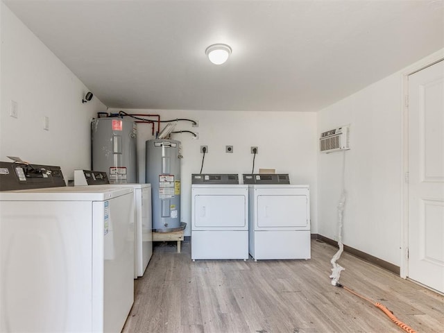 225 NW 24th St, Oklahoma City, OK 73103 - washroom featuring light wood-type flooring, a wall mounted air conditioner, water heater, and washer and clothes dryer