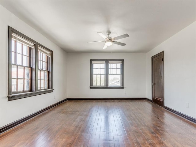 225 NW 24th St, Oklahoma City, OK 73103 - spare room featuring dark wood-type flooring, baseboards, and a ceiling fan