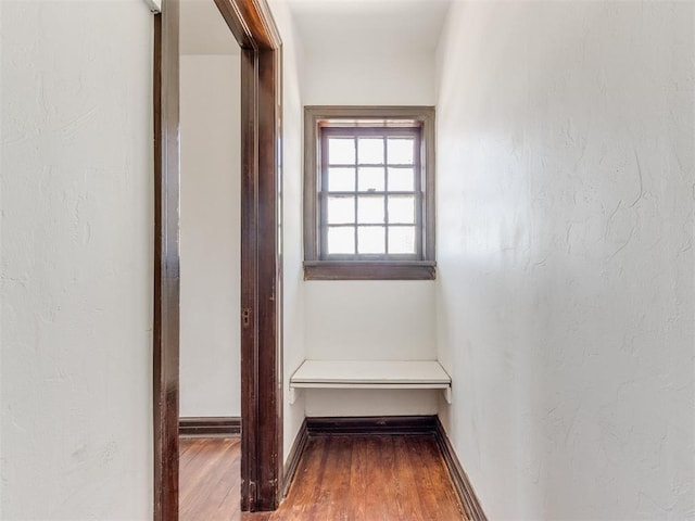 225 NW 24th St, Oklahoma City, OK 73103 - hallway featuring a textured wall, baseboards, and wood finished floors