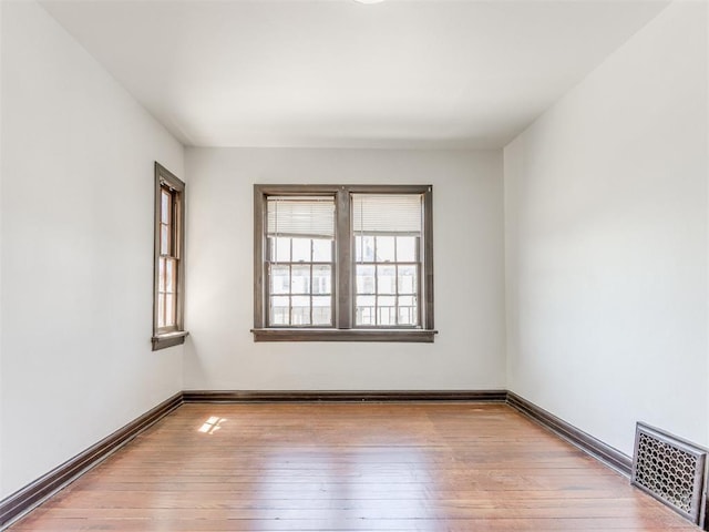 225 NW 24th St, Oklahoma City, OK 73103 - empty room featuring visible vents, baseboards, and hardwood / wood-style floors