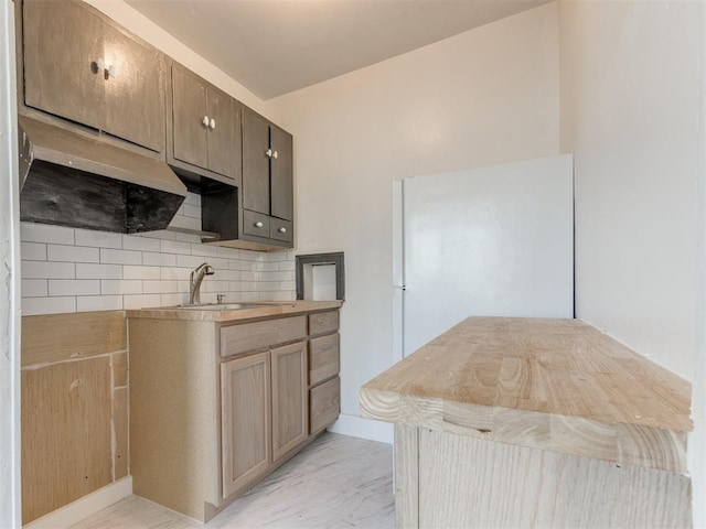 225 NW 24th St, Oklahoma City, OK 73103 - kitchen featuring light countertops, a sink, marble finish floor, and backsplash