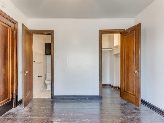 225 NW 24th St, Oklahoma City, OK 73103 - unfurnished bedroom with baseboards, a closet, crown molding, and wood finished floors