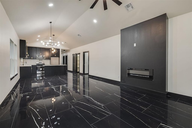 528 NW 112th St, Oklahoma City, OK 73114 - kitchen with dark marble finish floors, appliances with stainless steel finishes, light countertops, vaulted ceiling, and ceiling fan