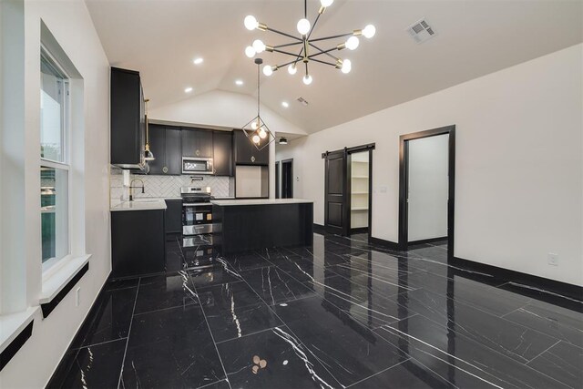 528 NW 112th St, Oklahoma City, OK 73114 - kitchen with appliances with stainless steel finishes, light countertops, lofted ceiling, dark cabinetry, and dark marble finish flooring