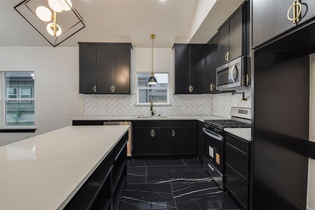 528 NW 112th St, Oklahoma City, OK 73114 - kitchen with stainless steel appliances, a sink, dark cabinetry, and dark marble finish flooring