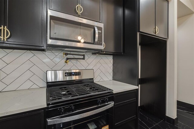 528 NW 112th St, Oklahoma City, OK 73114 - kitchen with appliances with stainless steel finishes, dark cabinets, light countertops, and backsplash