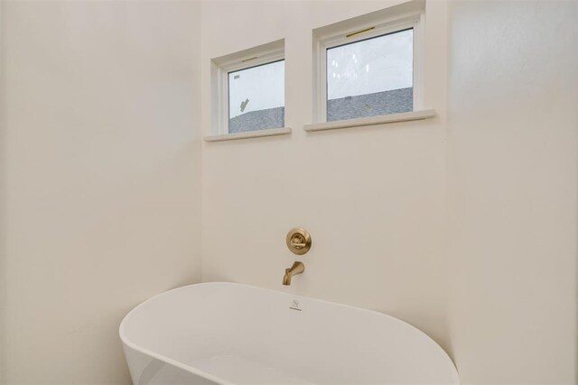 528 NW 112th St, Oklahoma City, OK 73114 - bathroom with healthy amount of natural light and a freestanding bath