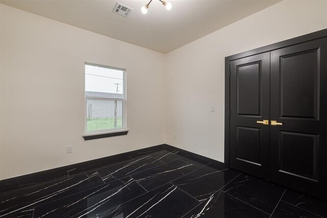 528 NW 112th St, Oklahoma City, OK 73114 - empty room featuring marble tiled flooring and baseboards