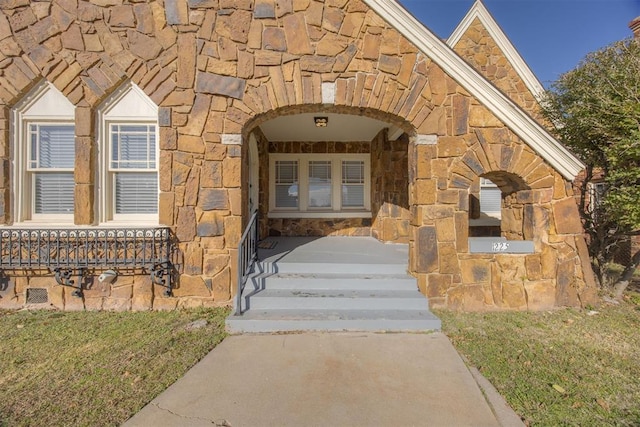 doorway to property with stone siding