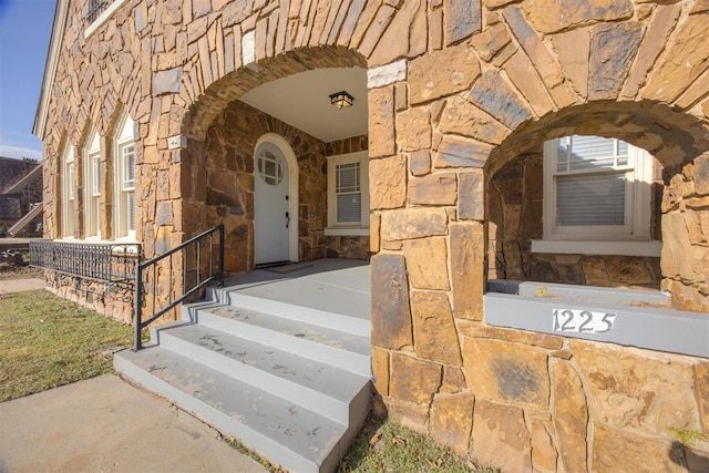 property entrance with stone siding