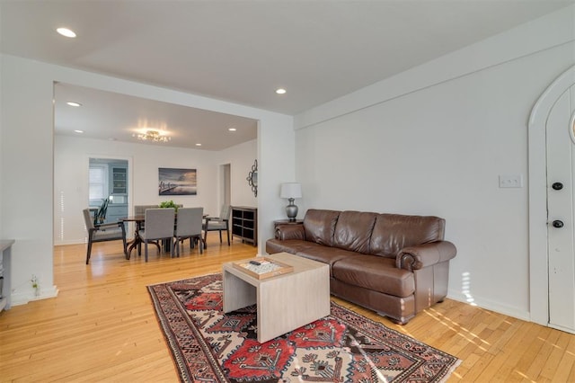 living room featuring recessed lighting, light wood-type flooring, and baseboards