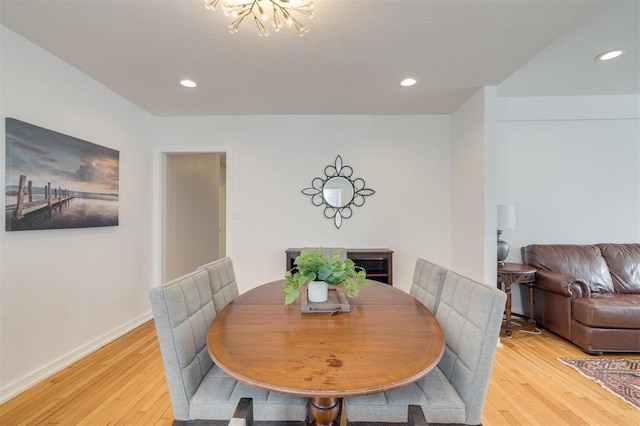 dining area with light wood-style flooring, a chandelier, and recessed lighting